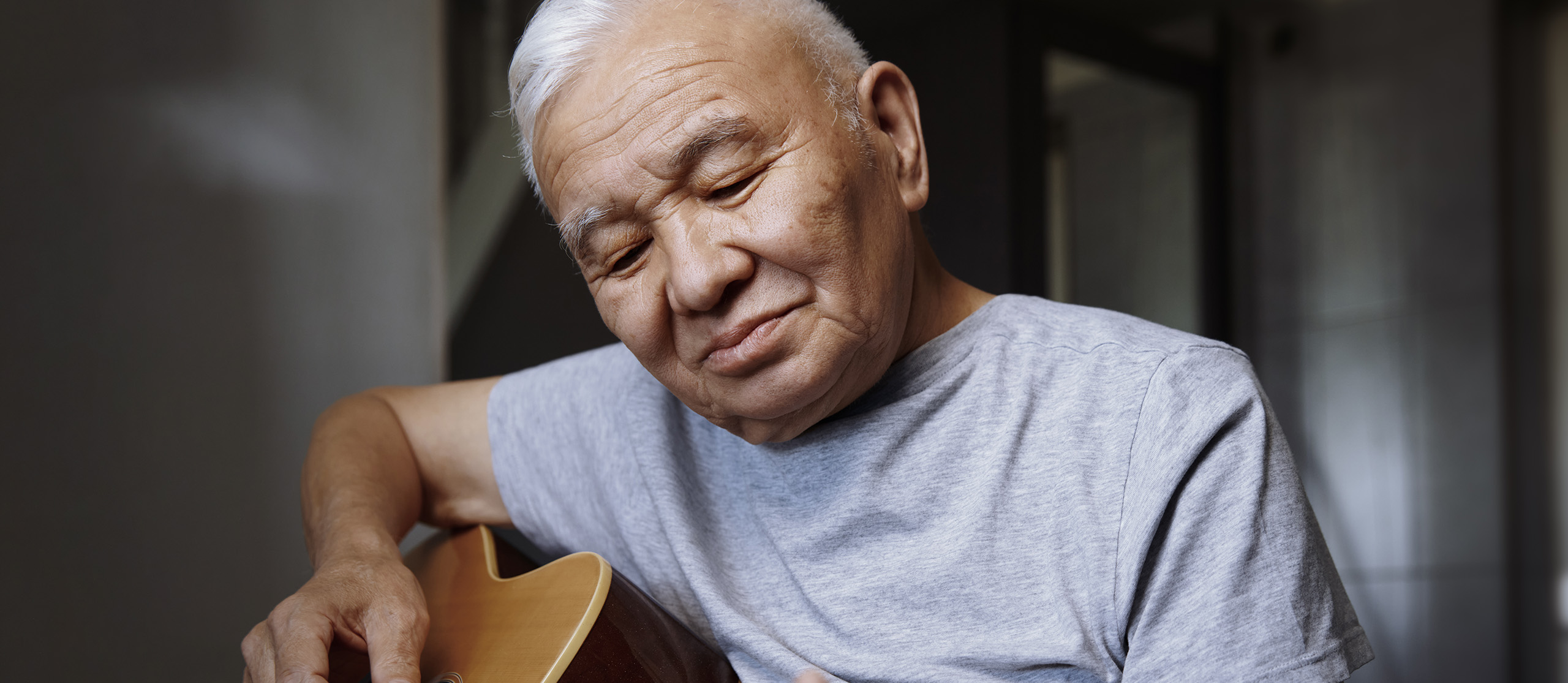 middle aged man playing guitar
