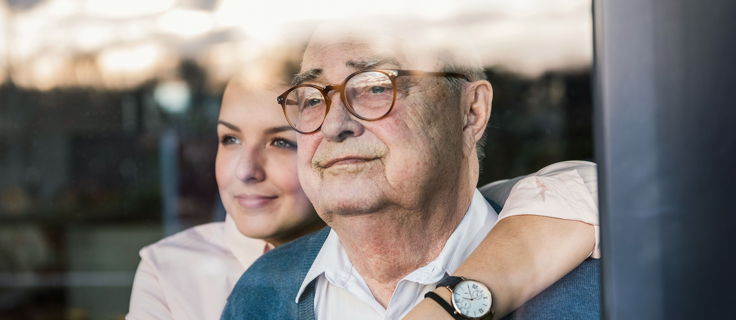 Older man hugging his adult daughter