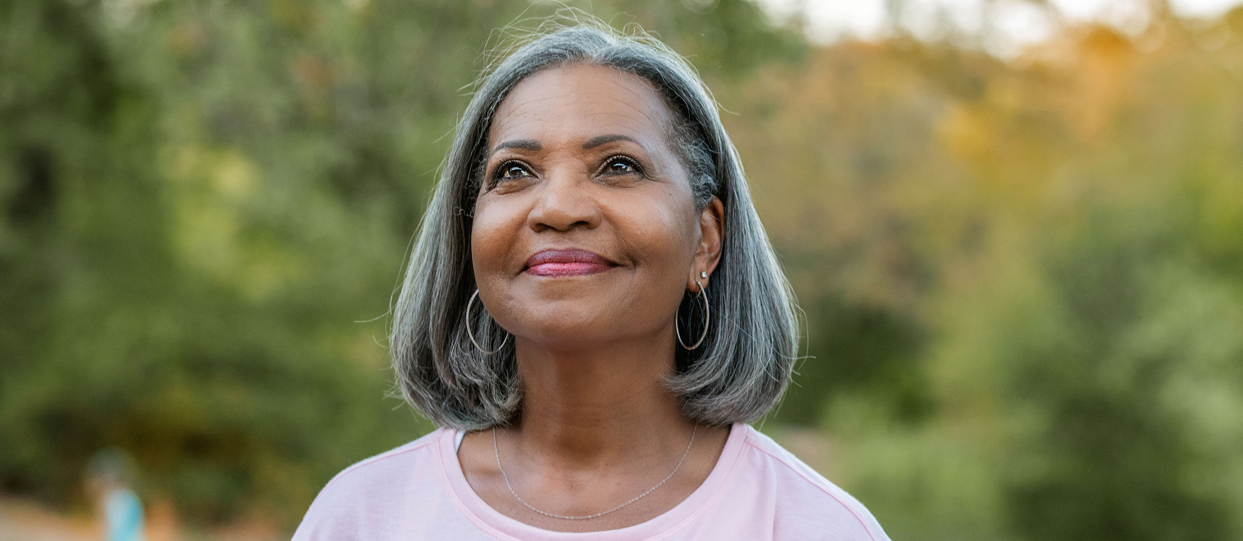 Older woman looking into sky