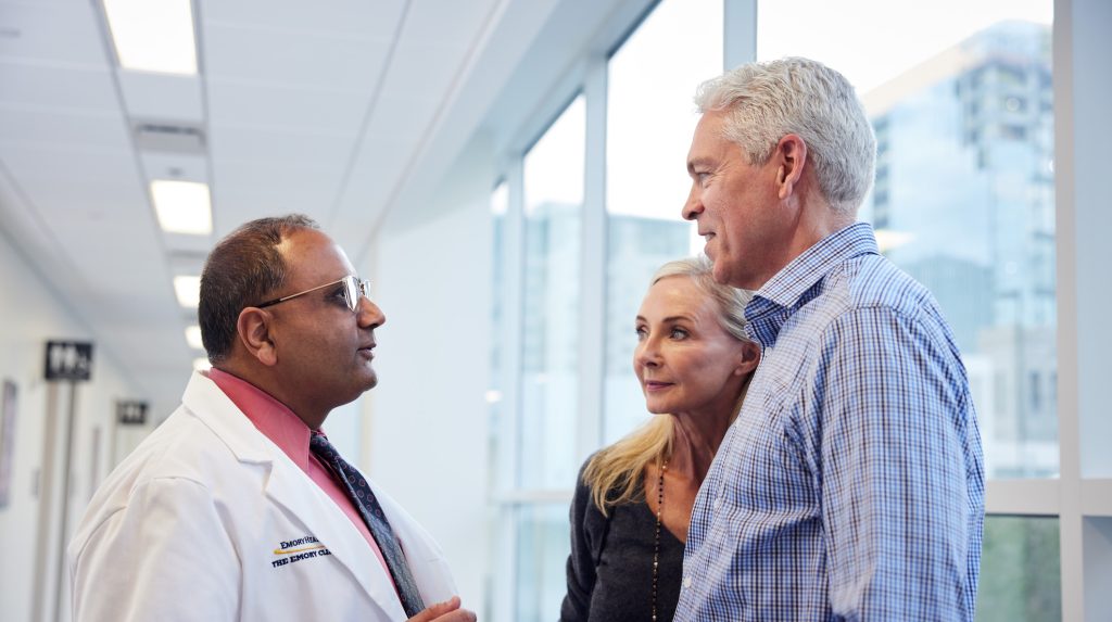 Doctor talking to a man and woman